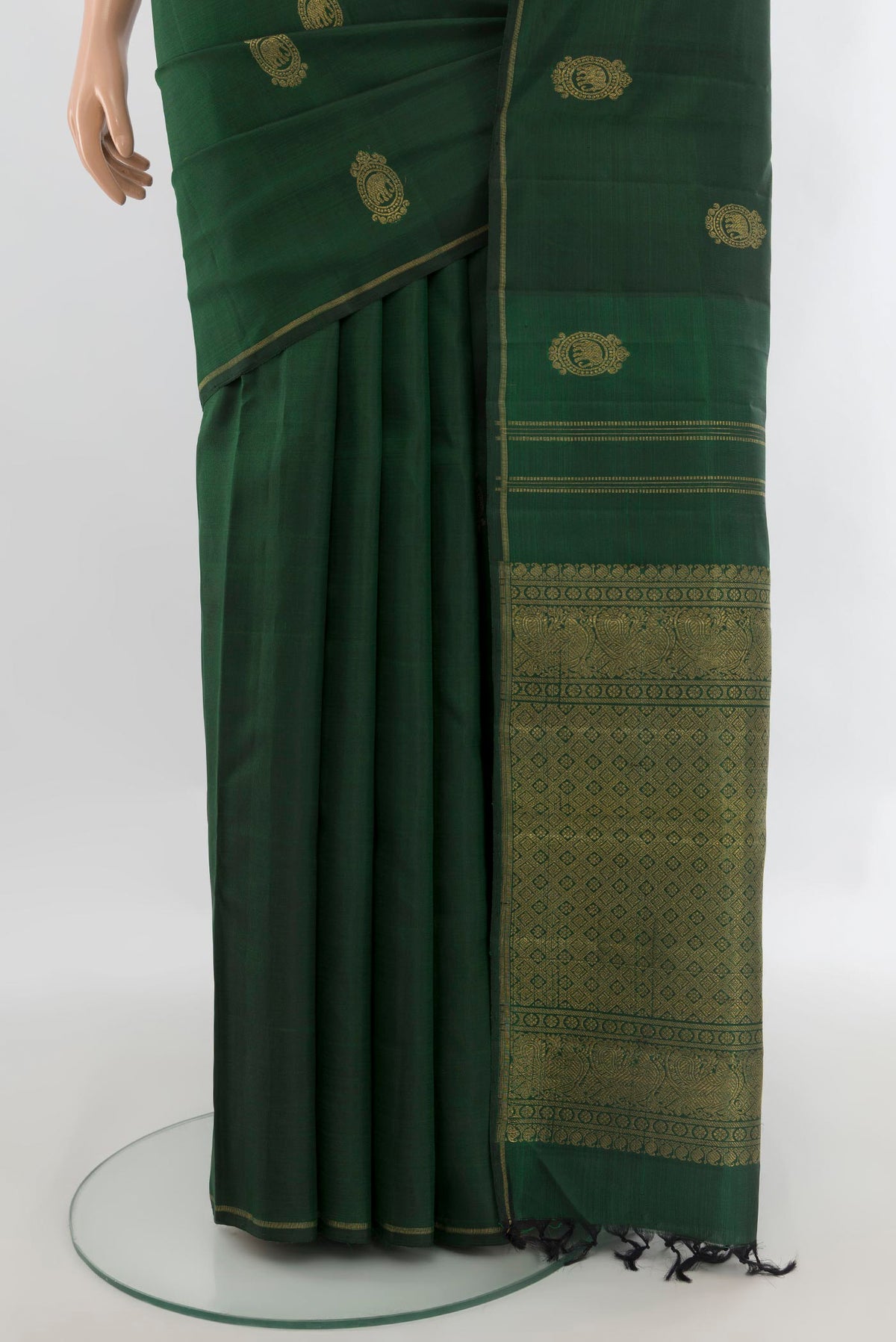 Pleats and pallu of Pure Silk Pure Zari Bottle Green Kanchipuram Saree with Zari Butta on the body and Thin Zari Line. 