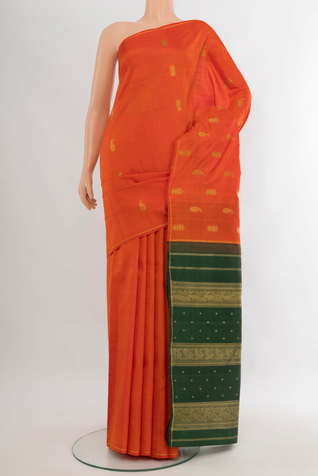 Pure Silk Pure Zari Brick Orange Kanchipuram Saree with Zari Butta on the body and Thin Zari Line.  displayed on a mannequin