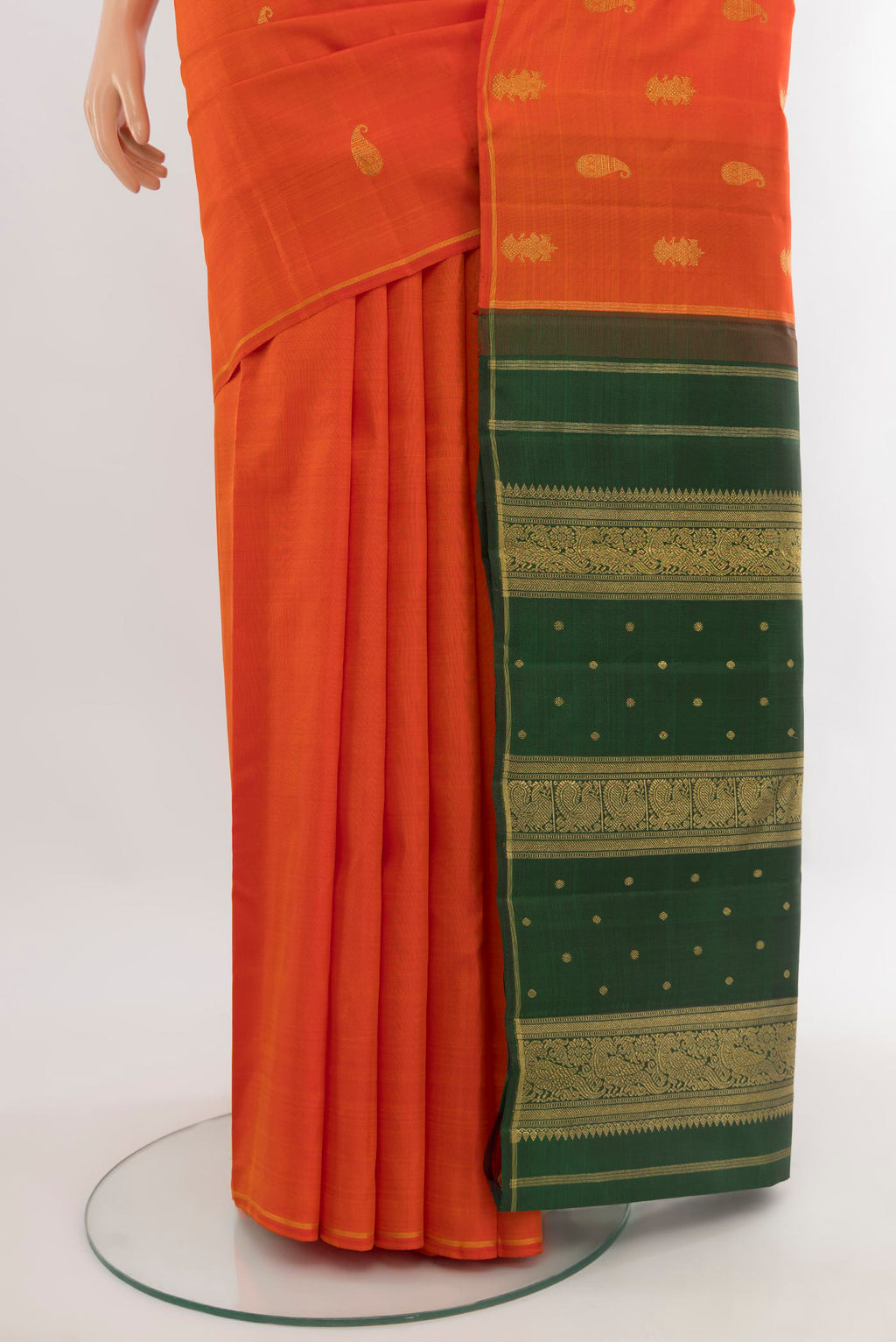 Pleats and pallu of Pure Silk Pure Zari Brick Orange Kanchipuram Saree with Zari Butta on the body and Thin Zari Line. 