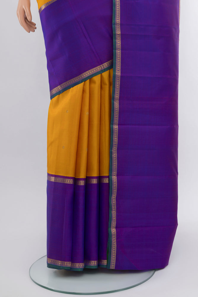 Pleats and pallu of Pure Silk Pure Zari Mustard Kanchipuram Saree with Zari Butta on the body and Silk Border. 