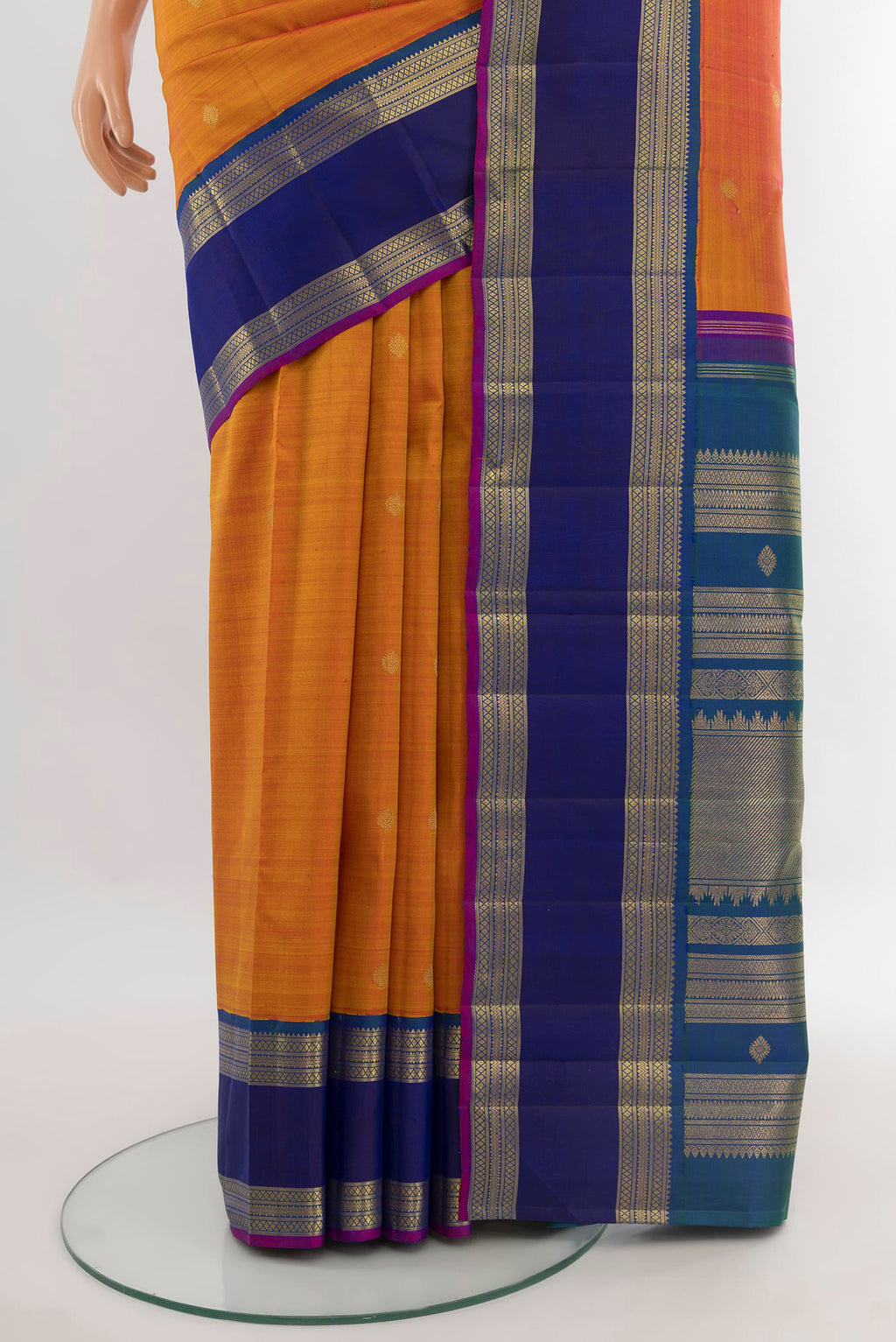 Pleats and pallu of Rust Kanjivaram Silk Saree with Zari Butta on the body and Zari Border. 