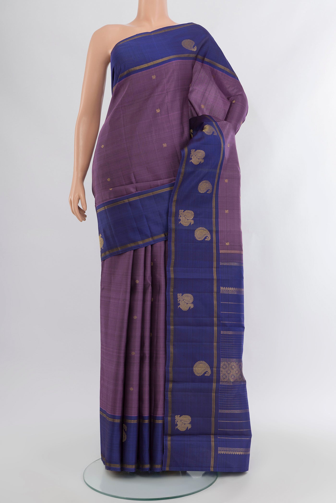 Pure Silk Pure Zari Violet Kanjivaram Saree with Zari Butta on the body and Plain Border.  displayed on a mannequin