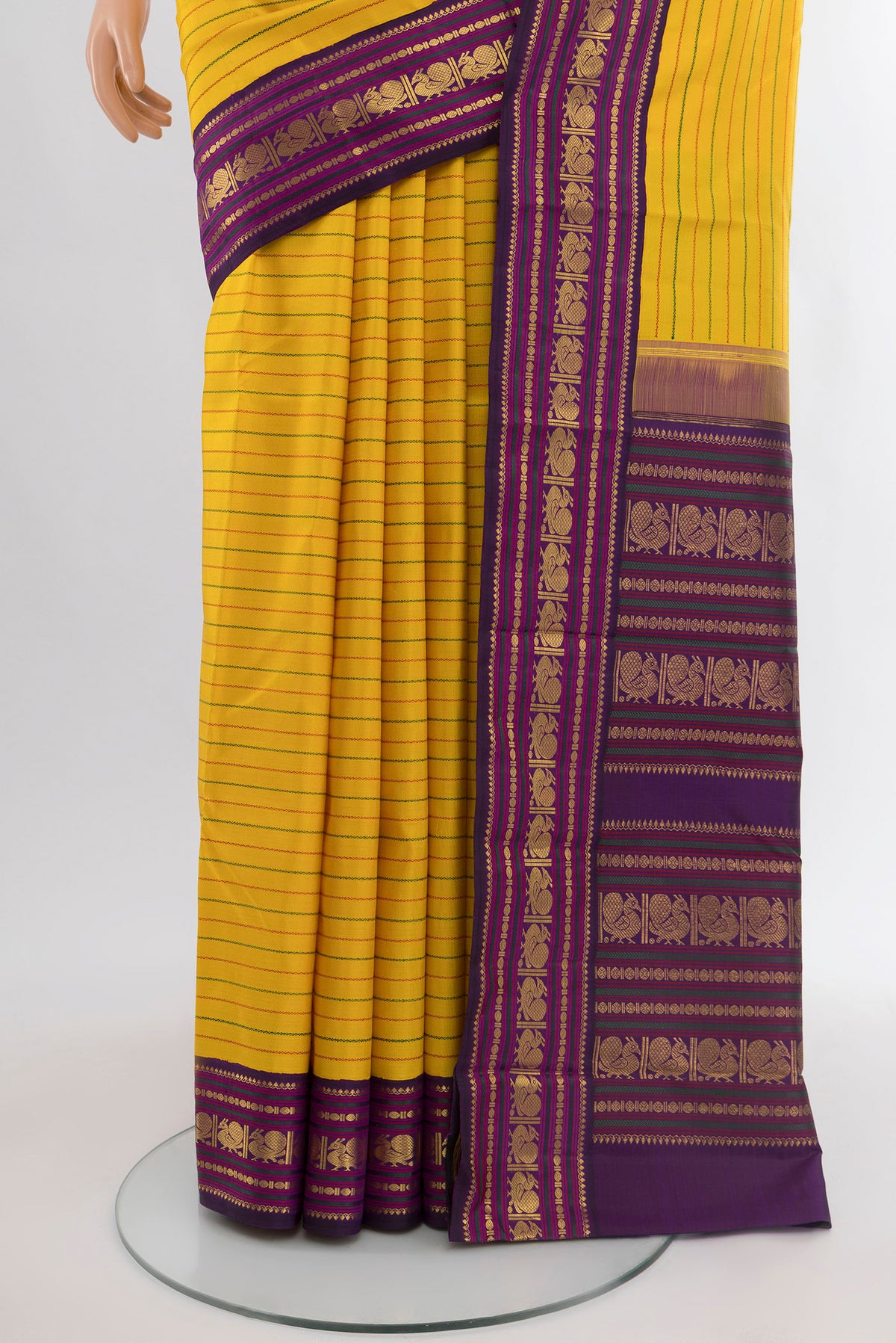 Pleats and pallu of Yellow Kanjivaram Silk Saree with Stripes on the body and Zari Border. 