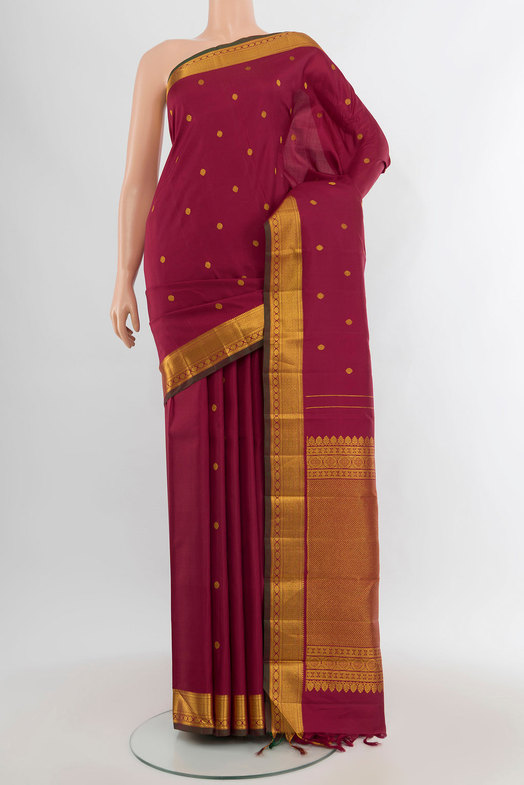 Maroon Kanchipuram Silk Saree with Zari Butta on the body and Zari Border.  displayed on a mannequin