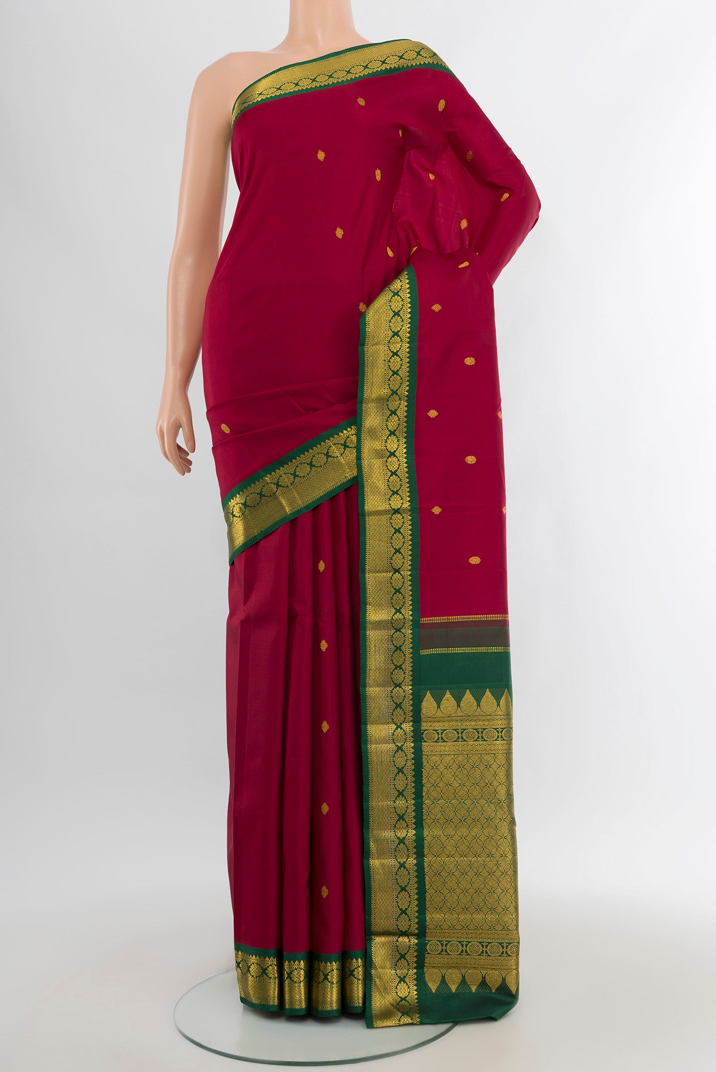 Maroon Kanchipuram Silk Saree with Zari Butta on the body and Zari Border.  displayed on a mannequin