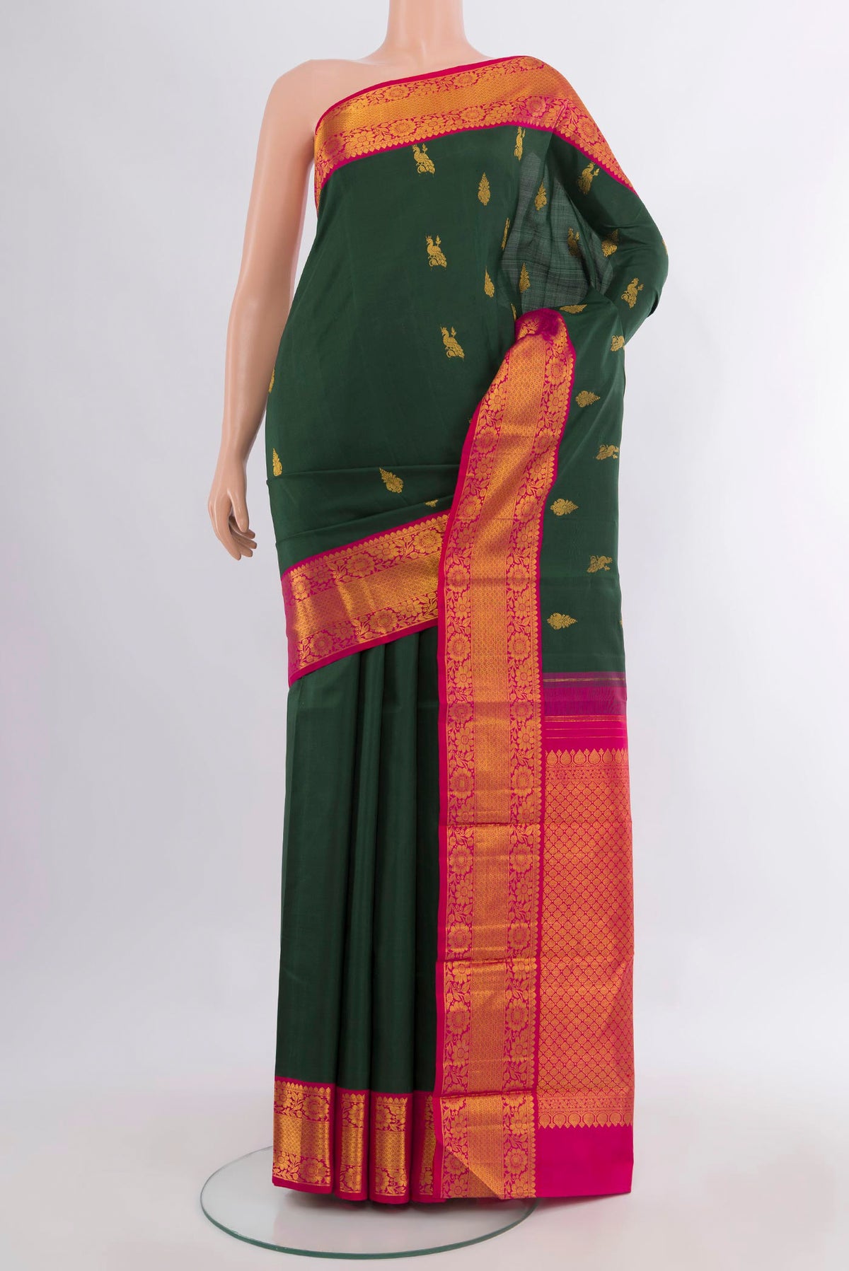 Pure Silk Bottle Green Kanjivaram Saree with Zari Butta on the body and Zari Border.  displayed on a mannequin