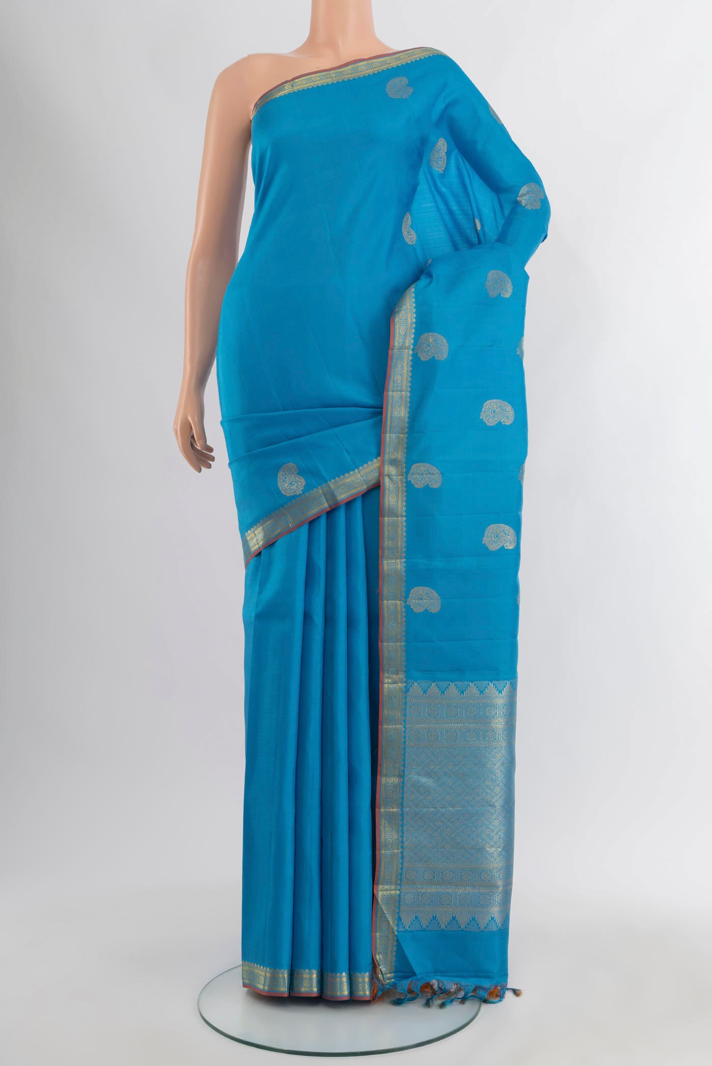 Blue Kanchipuram Silk Saree with Zari Butta on the body and Zari Border.  displayed on a mannequin