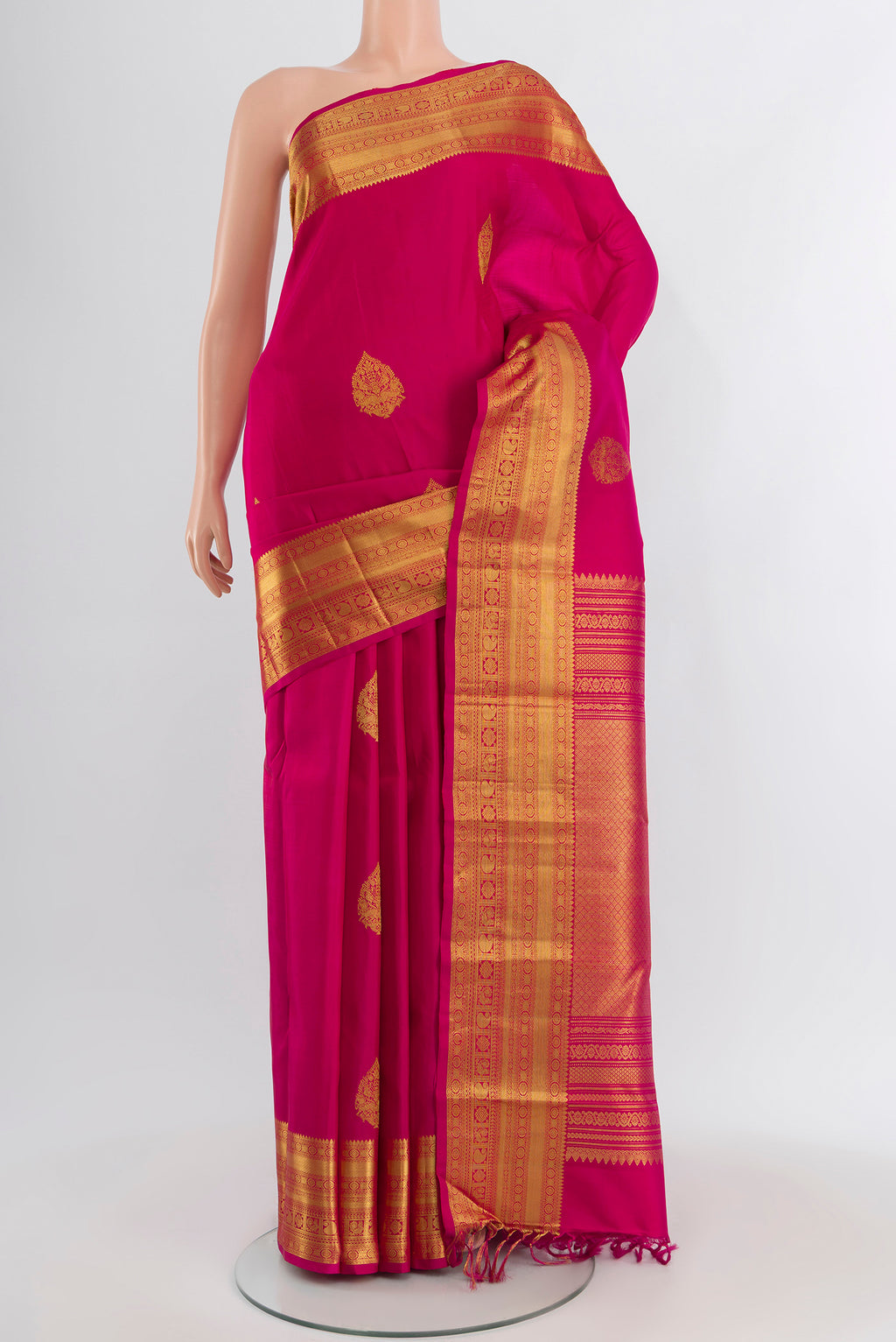 Dark Pink Kanjivaram Silk Saree with Zari Butta on the body and Zari Border.  displayed on a mannequin