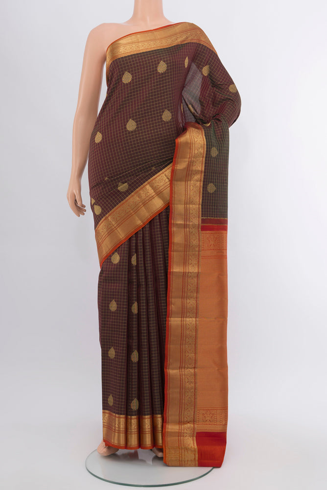 Mehandi Green Kanjivaram Silk Saree with Zari Butta on the body and Silk Border.  displayed on a mannequin