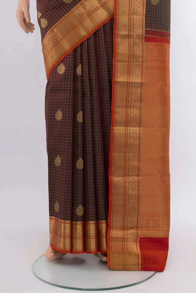 Pleats and pallu of Mehandi Green Kanjivaram Silk Saree with Zari Butta on the body and Silk Border. 