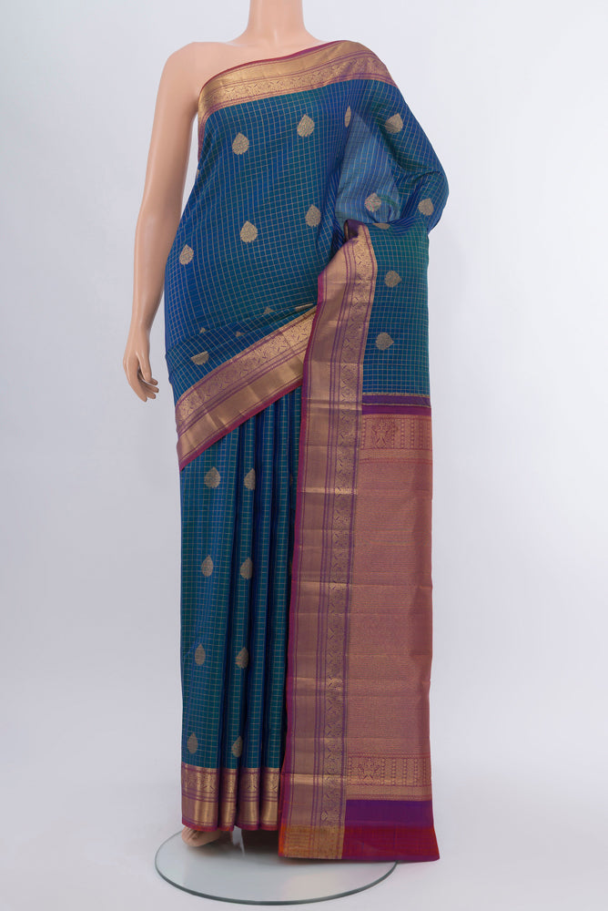Peacock Blue Kanjivaram Silk Saree with Checked design on the body and Silk Border.  displayed on a mannequin