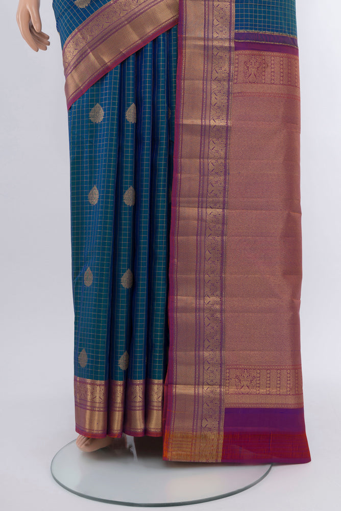 Pleats and pallu of Peacock Blue Kanjivaram Silk Saree with Checked design on the body and Silk Border. 