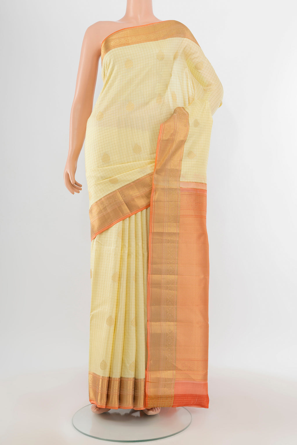 Cream Kanjivaram Silk Saree with Checked design on the body and Zari Border.  displayed on a mannequin