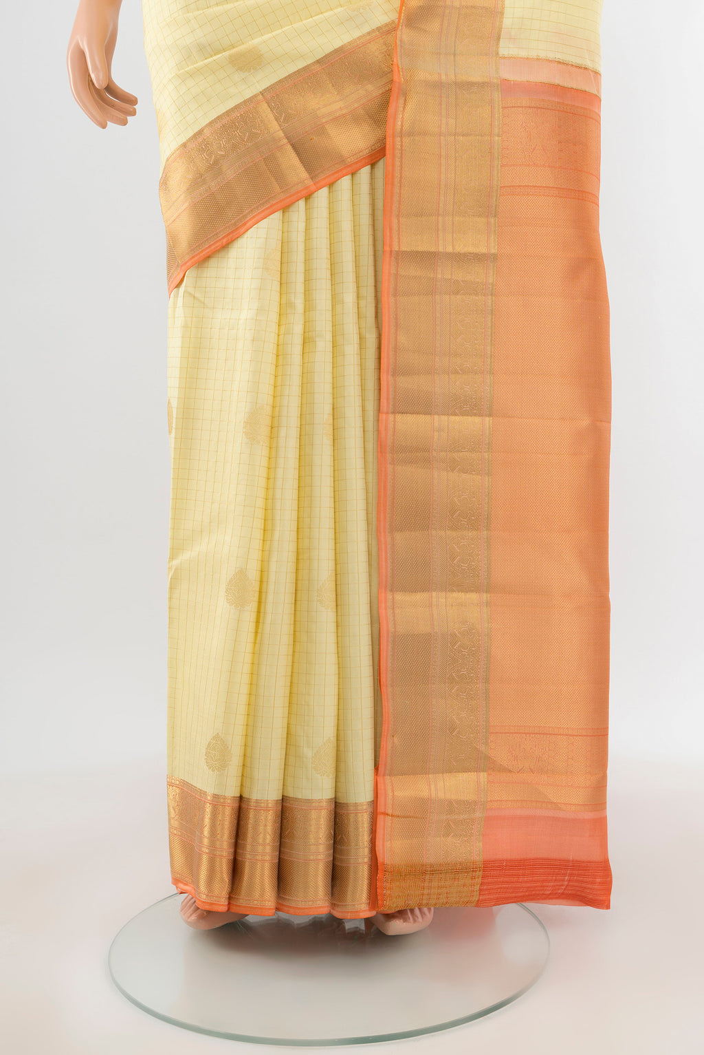 Pleats and pallu of Cream Kanjivaram Silk Saree with Checked design on the body and Zari Border. 