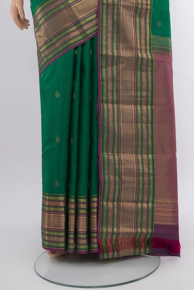 Pleats and pallu of Peacock Blue Kanchipuram Silk Saree with Zari Butta on the body and Silk Border. 