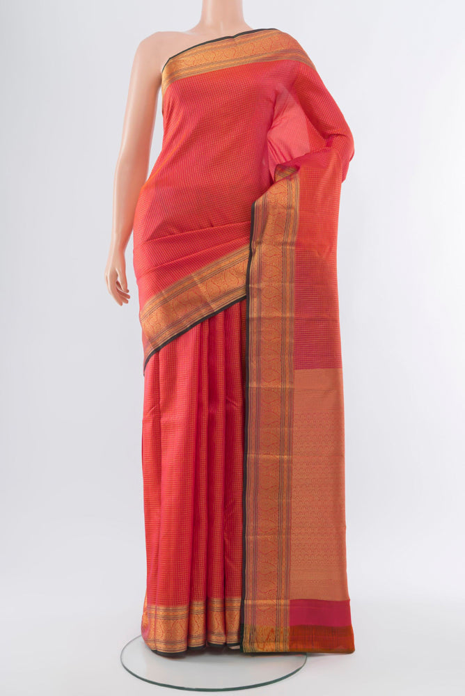 Golden Peach Kanchipuram Silk Saree with Zari Butta on the body and Silk Border.  displayed on a mannequin