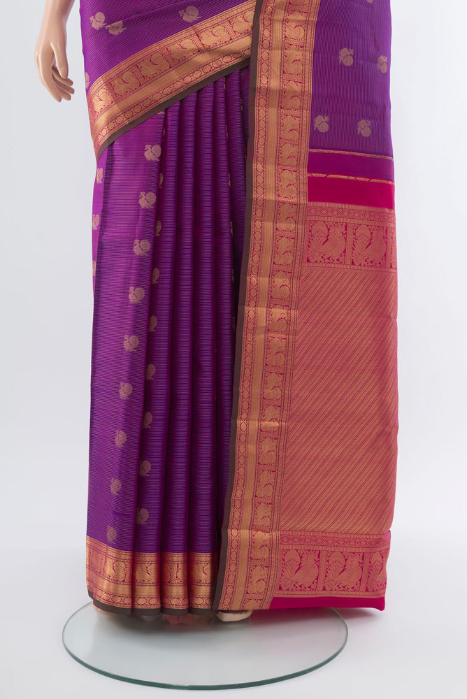 Pleats and pallu of Purple Kanchipuram Silk Saree with Zari Butta on the body and Silk Border. 
