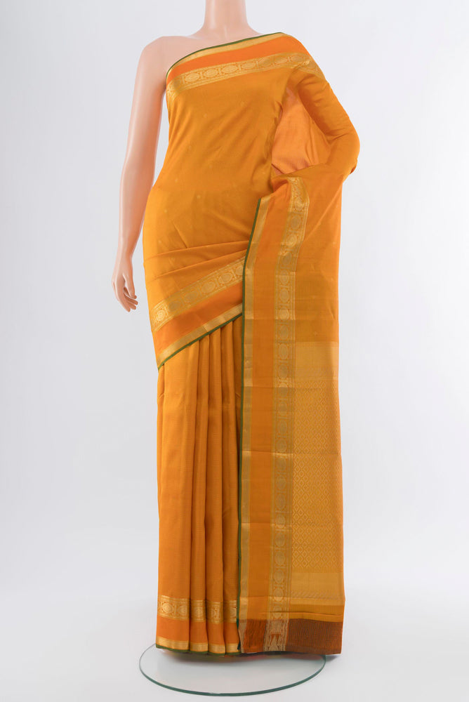 Orange Kanjivaram Silk Saree with Zari Butta on the body and Silk Border.  displayed on a mannequin