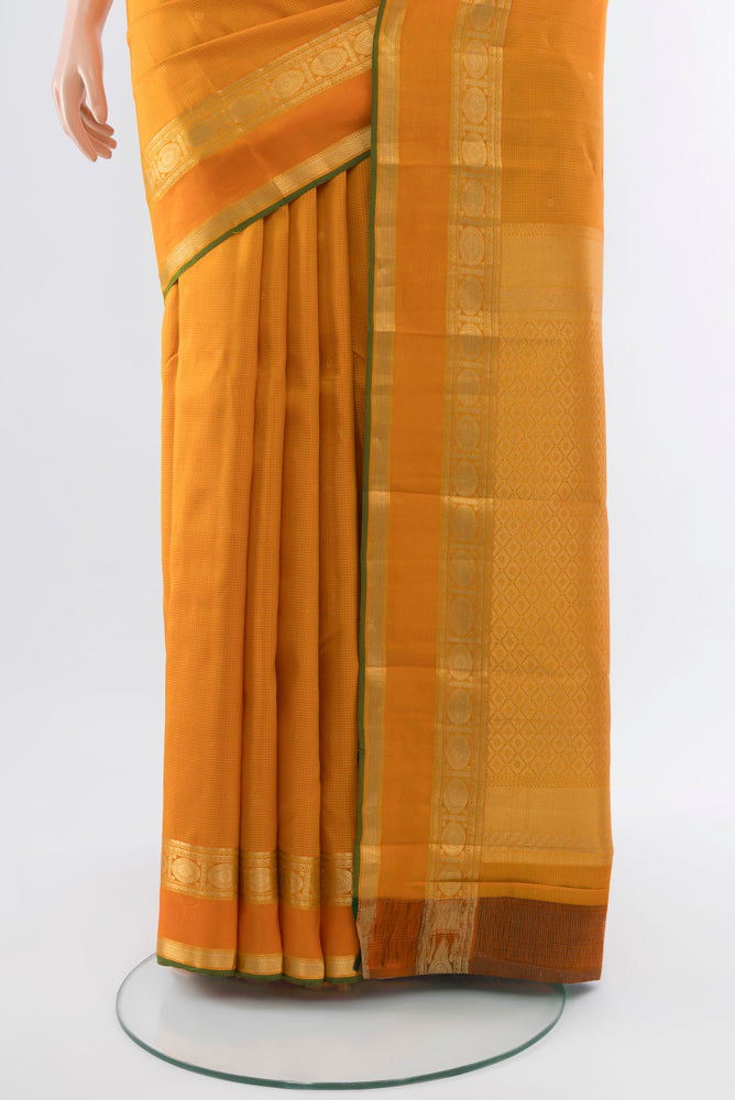 Pleats and pallu of Orange Kanjivaram Silk Saree with Zari Butta on the body and Silk Border. 