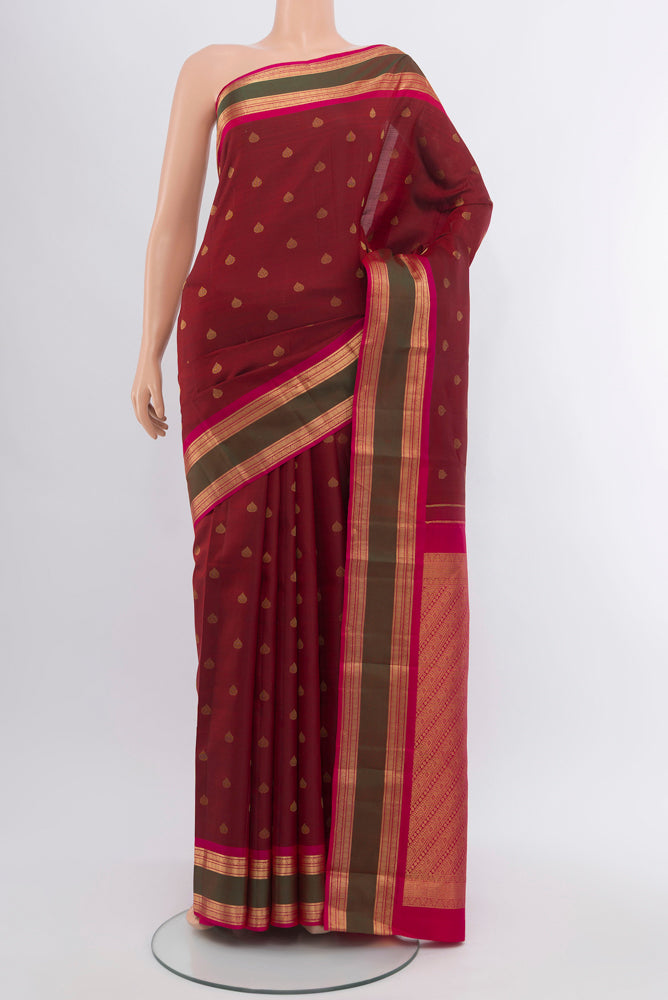 Maroon Kanchipuram Silk Saree with Zari Butta on the body and Silk Border.  displayed on a mannequin