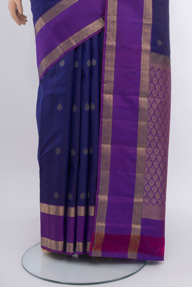 Pleats and pallu of Navy Blue Kanchipuram Silk Saree with Zari Butta on the body and Silk Border. 