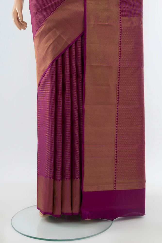 Pleats and pallu of Purple Kanchipuram Silk Saree with Zari Butta on the body and Silk Border. 