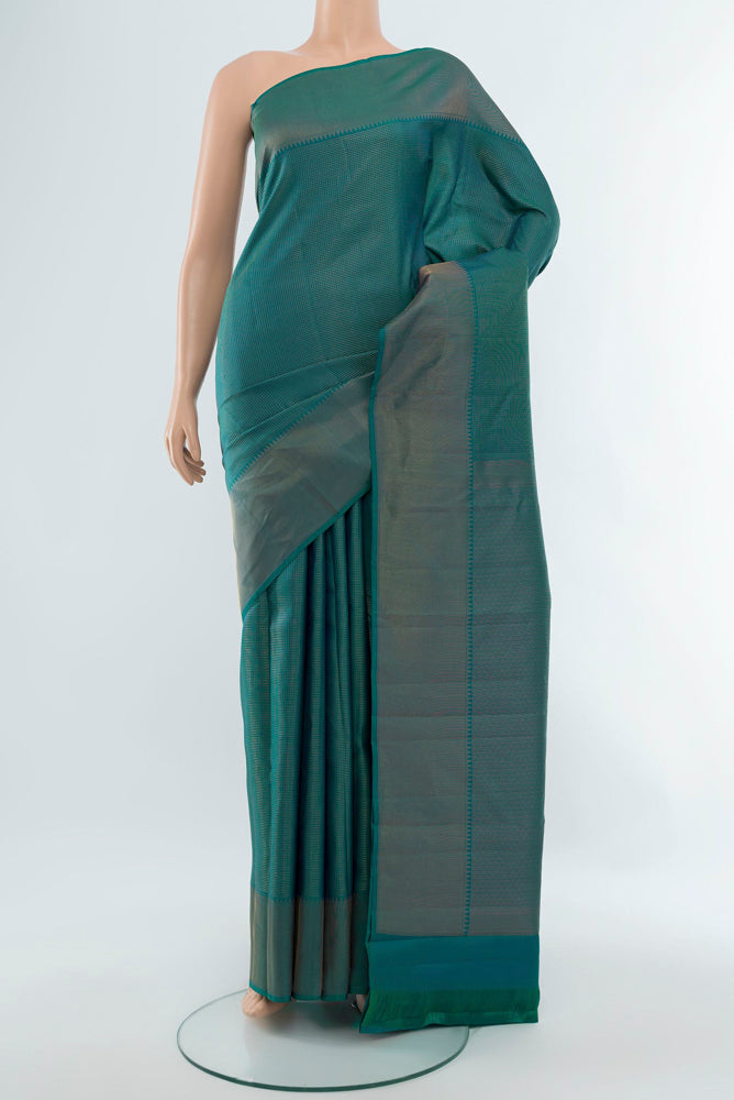 Peacock Blue Kanchipuram Silk Saree with Zari Butta on the body and Silk Border.  displayed on a mannequin