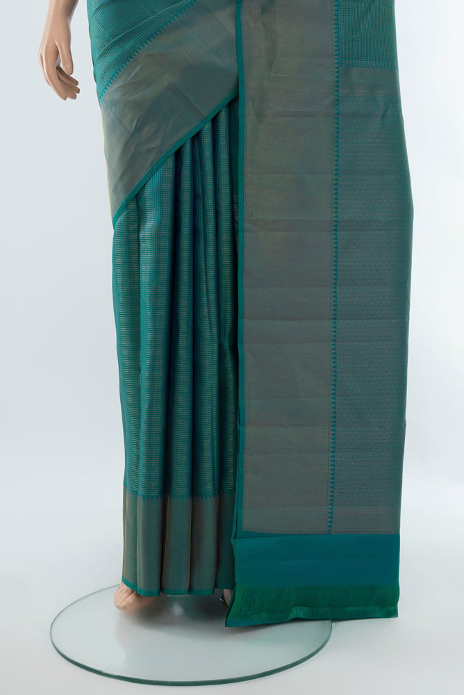 Pleats and pallu of Peacock Blue Kanchipuram Silk Saree with Zari Butta on the body and Silk Border. 
