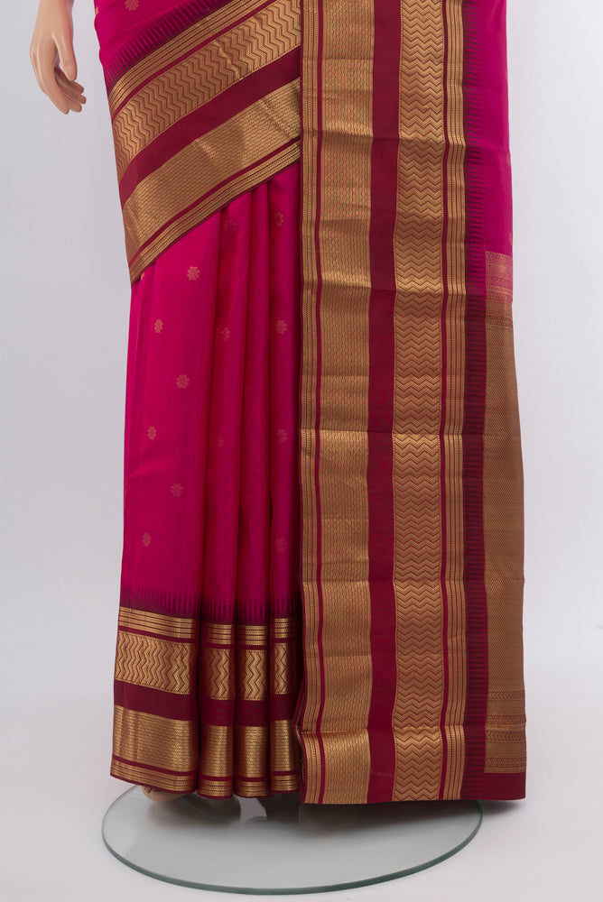 Pleats and pallu of Magenta Kanjivaram Silk Saree with Zari Butta on the body and Silk Border. 