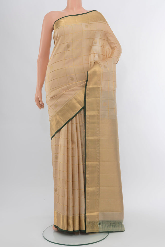 Dark Beige Kanjivaram Silk Saree with Zari Butta on the body and Silk Border.  displayed on a mannequin