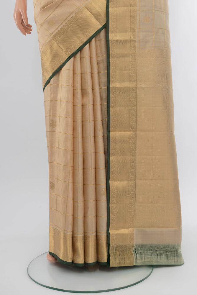 Pleats and pallu of Dark Beige Kanjivaram Silk Saree with Zari Butta on the body and Silk Border. 