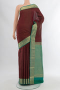 Coffee Brown Kanchipuram Silk Saree with Zari Butta on the body and Silk Border.  displayed on a mannequin