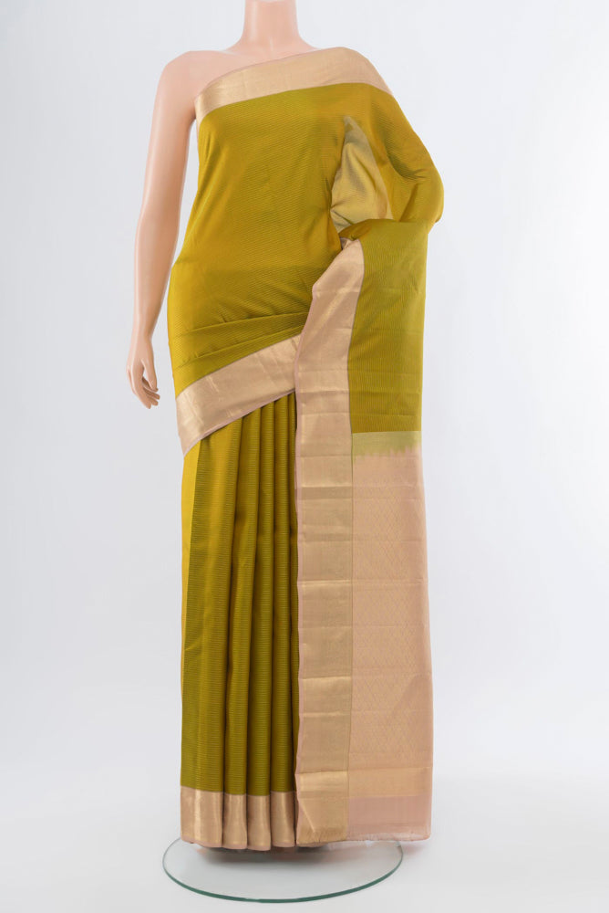 Mehandi Green Kanchipuram Silk Saree with Zari Butta on the body and Silk Border.  displayed on a mannequin