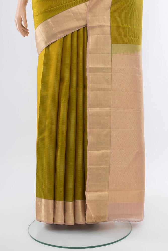 Pleats and pallu of Mehandi Green Kanchipuram Silk Saree with Zari Butta on the body and Silk Border. 
