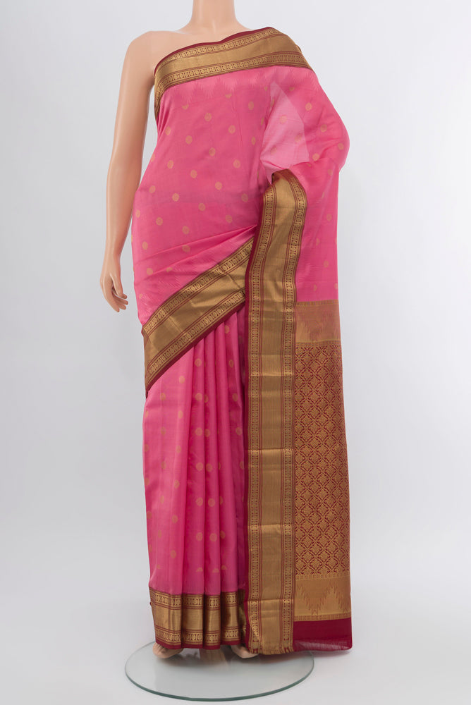 Rose pink Kanchipuram Silk Saree with Zari Butta on the body and Silk Border.  displayed on a mannequin