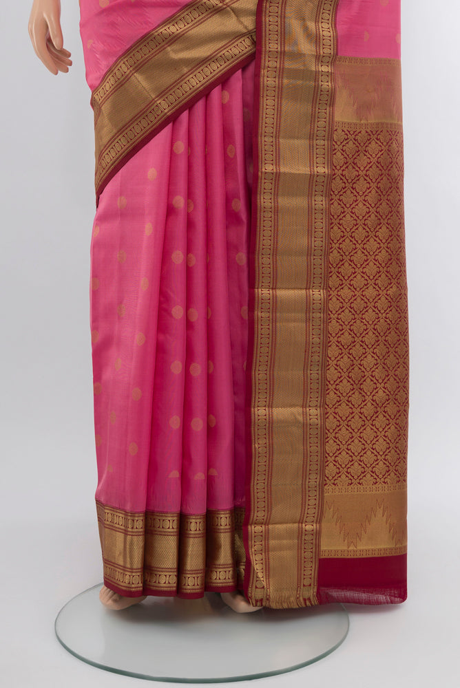 Pleats and pallu of Rose pink Kanchipuram Silk Saree with Zari Butta on the body and Silk Border. 