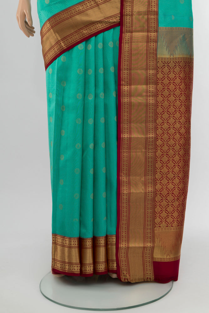 Pleats and pallu of Sky Blue Kanchipuram Silk Saree with Zari Butta on the body and Silk Border. 