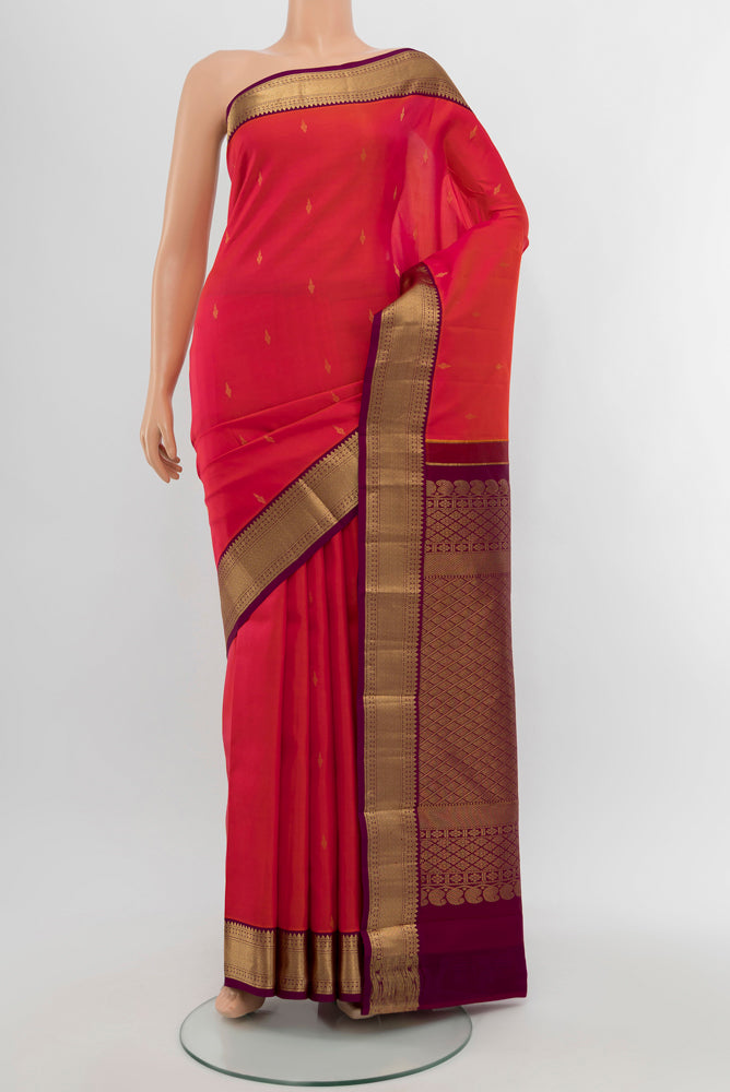 Peach Kanchipuram Silk Saree with Plain Body and Silk Border.  displayed on a mannequin