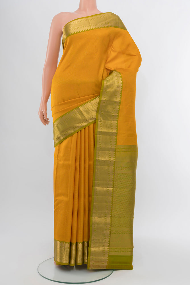 Yellow Kanjivaram Silk Saree with Zari Butta on the body and Silk Border.  displayed on a mannequin