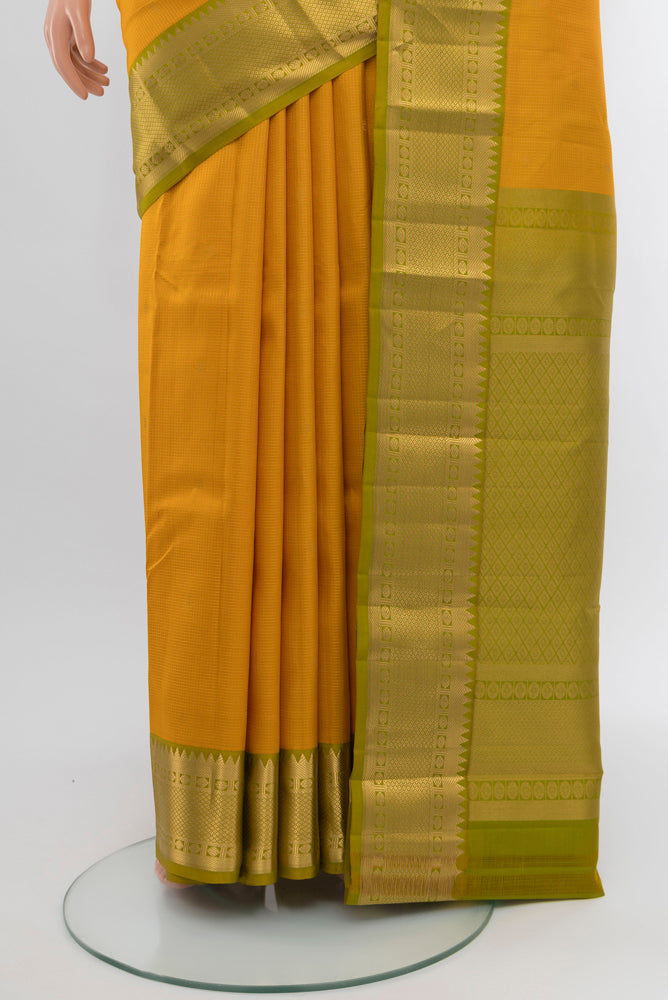 Pleats and pallu of Yellow Kanjivaram Silk Saree with Zari Butta on the body and Silk Border. 
