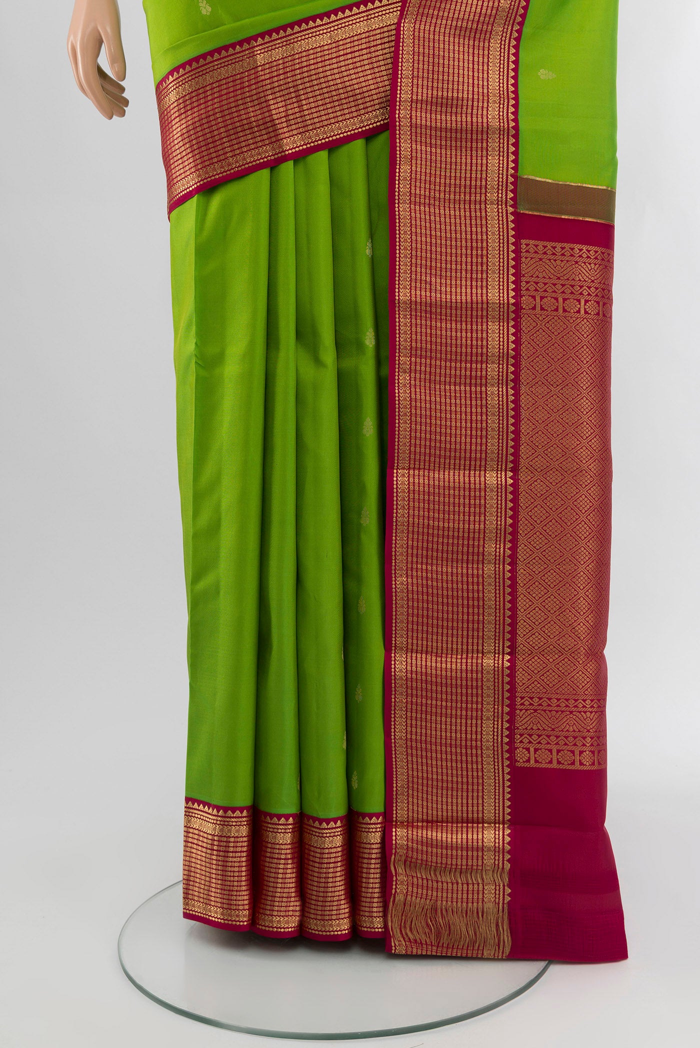 Pleats and pallu of Parrot Green Kanchipuram Silk Saree with Zari Butta on the body and Zari Border. 