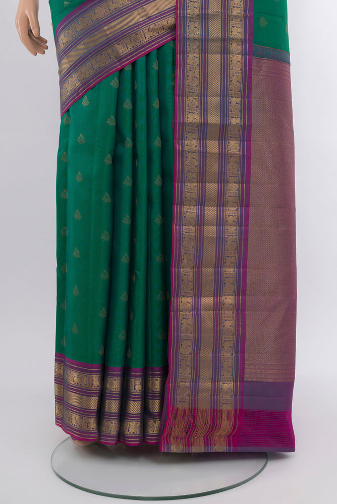 Pleats and pallu of Peacock Blue Kanchipuram Silk Saree with Zari Butta on the body and Silk Border. 