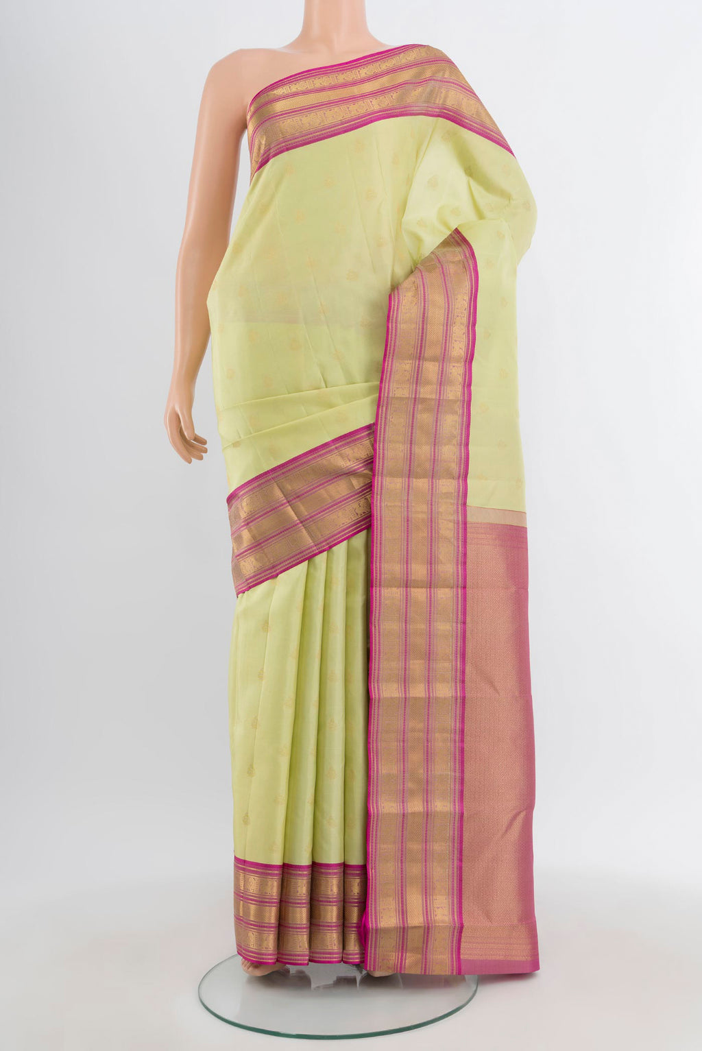 Pista Green Kanchipuram Silk Saree with Zari Butta on the body and Zari Border.  displayed on a mannequin