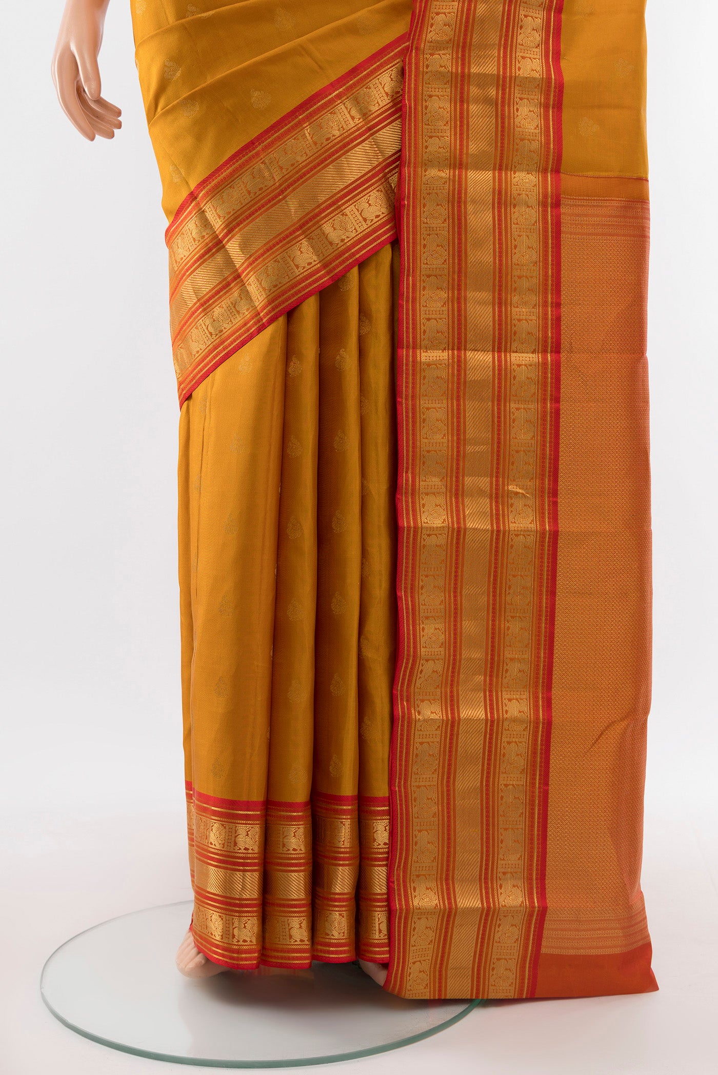 Pleats and pallu of Pure Silk Pure Zari Mustard Kanchipuram Saree with Zari Butta on the body and Silk Border. 