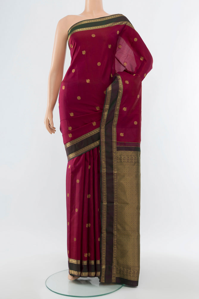 Purple Kanchipuram Silk Saree with Zari Butta on the body and Silk Border.  displayed on a mannequin