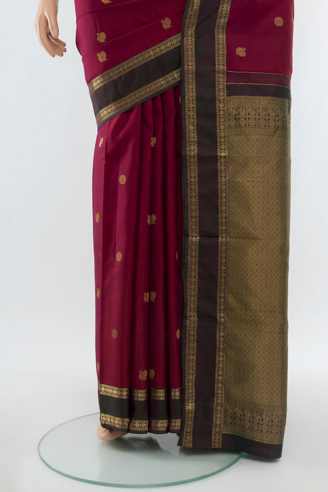Pleats and pallu of Purple Kanchipuram Silk Saree with Zari Butta on the body and Silk Border. 