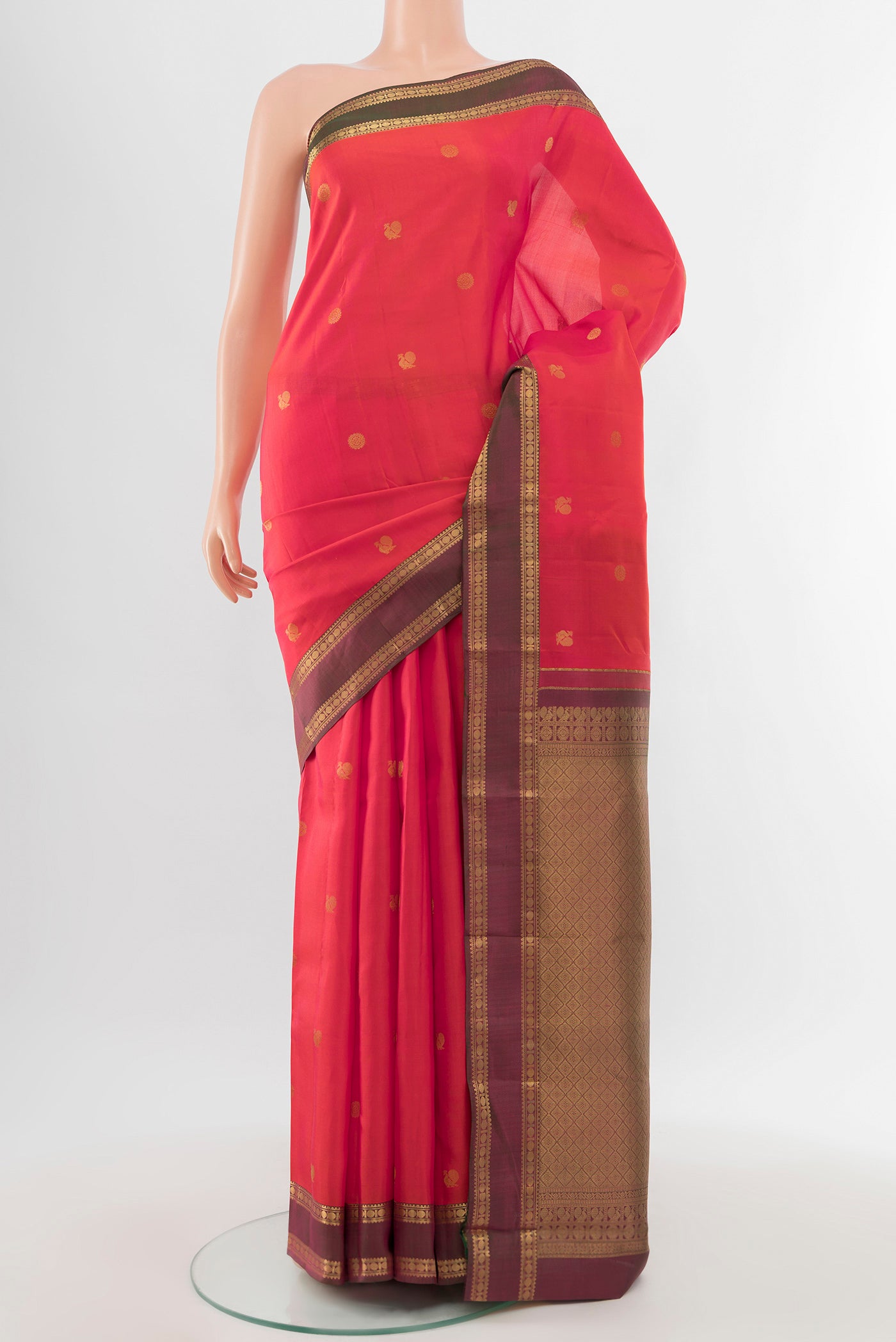 Pure Silk Pure Zari Peach Kanchipuram Saree with Zari Butta on the body and Silk Border.  displayed on a mannequin
