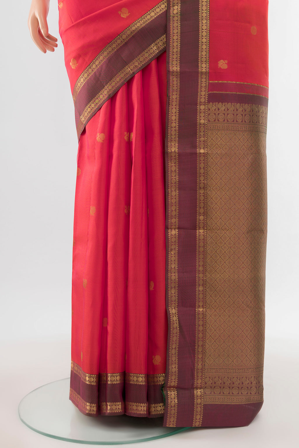 Pleats and pallu of Pure Silk Pure Zari Peach Kanchipuram Saree with Zari Butta on the body and Silk Border. 