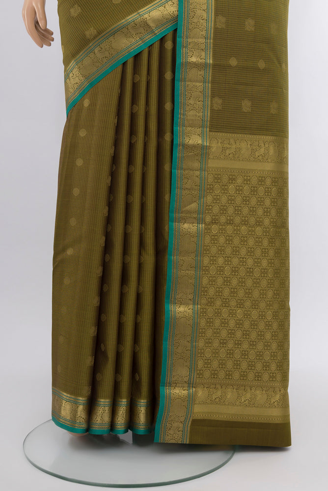 Pleats and pallu of Mehandi Green Kanchipuram Silk Saree with Zari Butta on the body and Silk Border. 