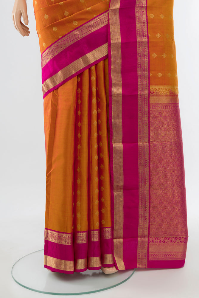 Pleats and pallu of Golden Peach Kanchipuram Silk Saree with Zari Butta on the body and Silk Border. 